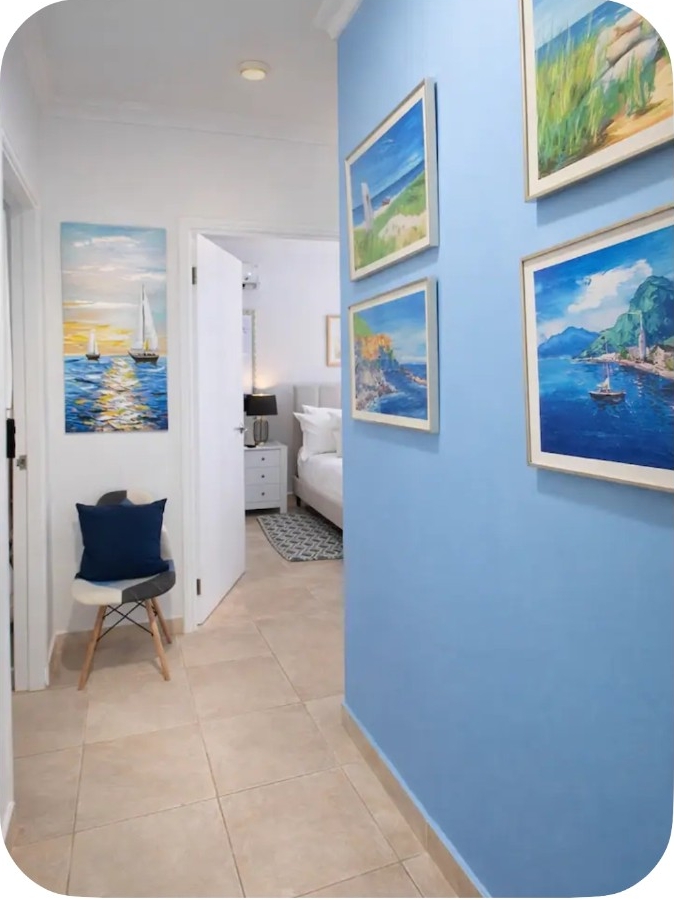 Bright hallway with colourful coastal artwork